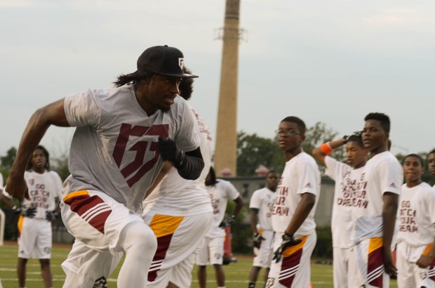 Robert Griffin III runs a drill during his first-ever "Friday Night Lights" football camp at Anacostia Senior High on Friday, June 13.