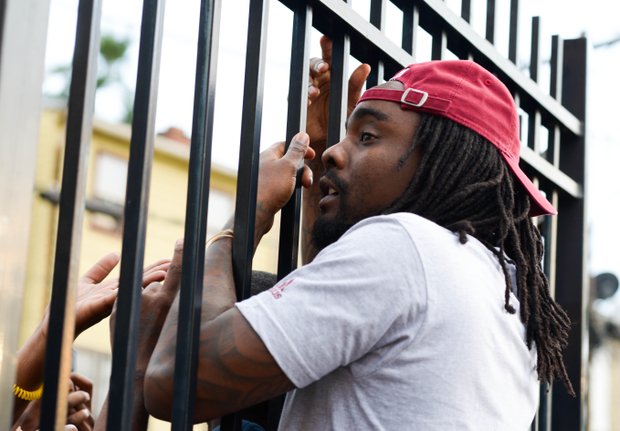 D.C.-based rapper Wale greets fans at the gate during Robert Griffin III first-ever "Friday Night Lights" football camp at Anacostia Senior High on Friday, June 13.