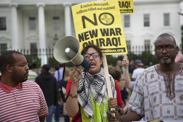 Heather Bennom of D.C. speaks through a megaphone in front of the White House on June 21 during a demonstration against new military action in Iraq.