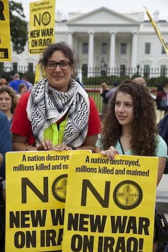 Heather Bennom, 33, and Rose Marsh, 14, hold signs in front of the White House on June 21 during a demonstration against new military action in Iraq.