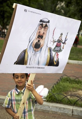 Hussein Himmad, a 5-year-old boy from Iraq, carries a sign decrying insurgent forces in his home country in front of the White House on June 21 during a demonstration against new military action in Iraq.