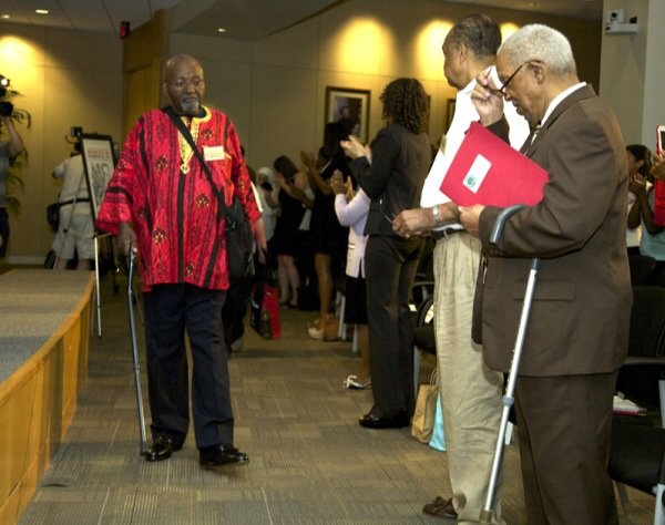 Freedom Rider John Moody walks to his seat during a June 2 ceremony at a U.S. Department of Education facility in Richmond, Virginia, to commemorate the 50th anniversary of the Civil Rights Act.