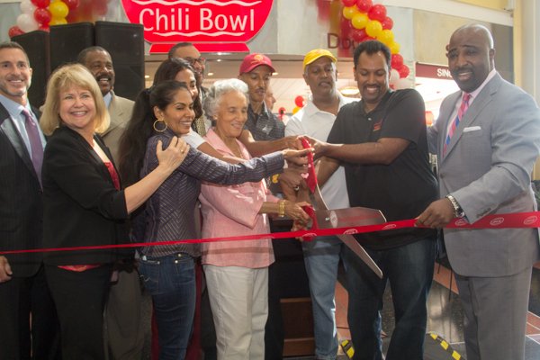 Ben's Chili Bowl family cut the ribbon Ben's during the opening of the restaurant's newest location at National Airport in Arlington, Va., on Wed., July 23.