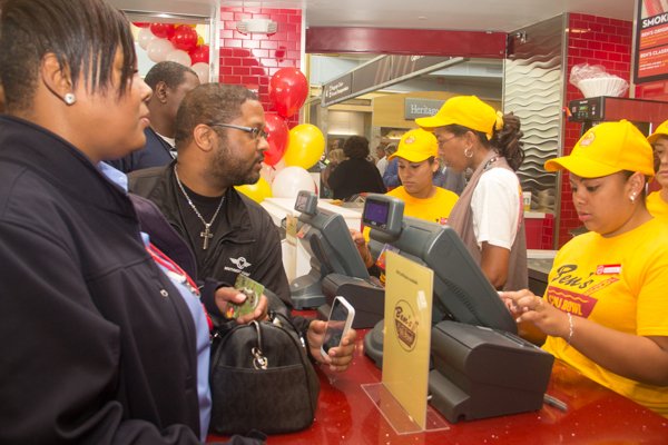 Camille Palmer (left) and Alan Pauls (right) are the first guests at Ben's Chili Bowl's newest location at National Airport in Arlington, Va., on Wed., July 23.