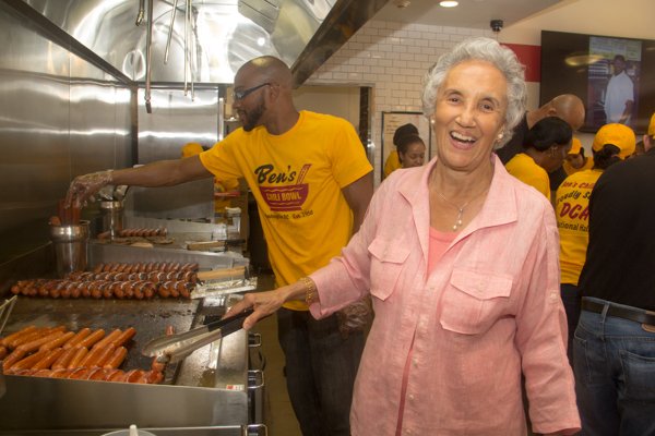 Ben's Chili Bowl matriarch, Virginia Ali, cooks a few half smokes during the opening of the restaurant's newest location at National Airport in Arlington, Va., on Wed., July 23.