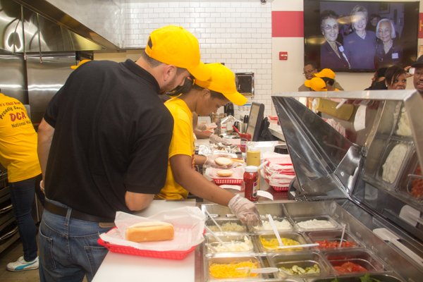 Ben's Chili Bowl employees prepare food during the opening of the restaurant's newest location at National Airport in Arlington, Va., on Wed., July 23.