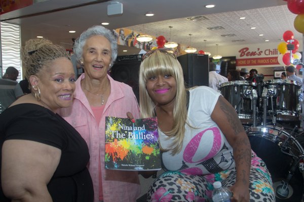 Ben's Chili Bowl matriarch Virginia Ali greets Michelle Williams Turnipseed (left) and Takeesa Donelson (right) during the opening of the restaurant's newest location at National Airport in Arlington, Va., on Wed., July 23.