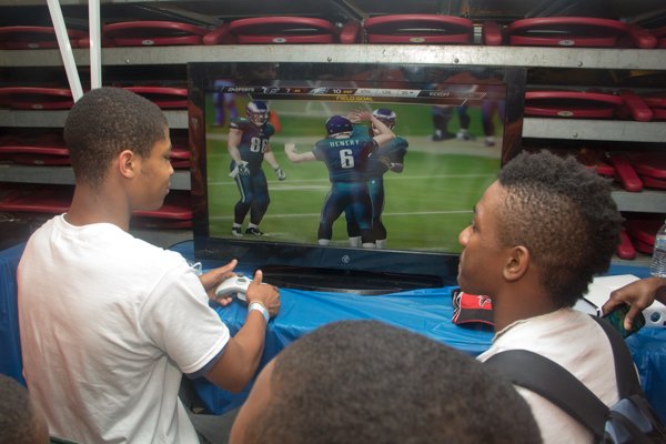 Mt. Pleasant Baptist Church summer camp teens, Jesse Garner and Clayton Washington, play Madden on the Xbox at the Thingamajig Conference hosted by the YMCA of Metropolitan Washington held at Show Place Arena in Upper Marlboro, Md., on Thurs., July 24.