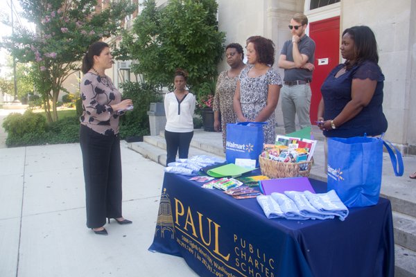Walmart Director of Community Affairs, Nina Albert, presents Paul PCS educators with $100 gift cards during the company's designation of July 25 through 31 as Teacher Appreciation Week at the school in Northwest on Monday, July 28.