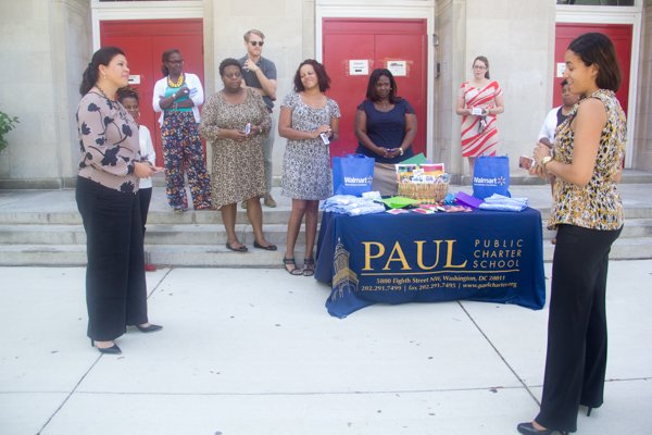 Takita W. Mason (right), director of development at Paul PCS thanks Walmart for the donation of school supplies and gift cards during the company's Teacher Appreciation Week in front of the charter school in Northwest on Monday, July 28.