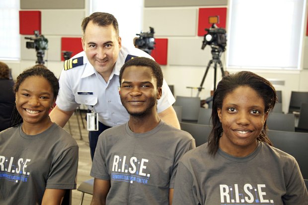 Lt. Commander John Chang of the U.S. Coast Guard Headquarters at St. Elizabeths East on August 13 with McKinley Tech students who created a robot. Seated left to right, , J’Niya Butler, 15 , Cabrel Foyet-Fokov, 17 and Angel Collins, 15