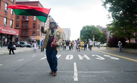 Man waves Pan-African flag as grassroots activists celebrate Marcus Mosiah Garvey's birthday. #HarlemWeek (08/17/2014)
