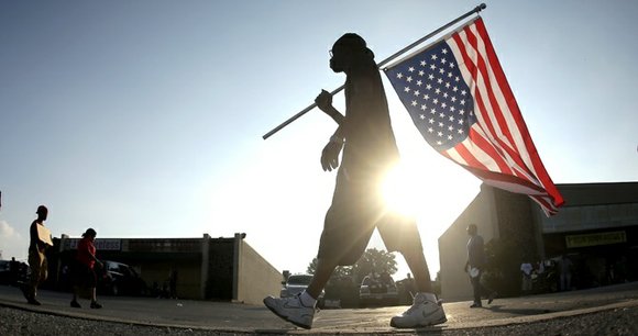 In the aftermath of the shooting death of Michael Brown, an unarmed, Black teenager by a White police officer in ... In the aftermath of the shooting death of Michael Brown, an unarmed, Black teenager by a White police officer in ...