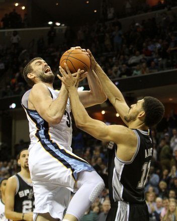 Grizz center Marc Gasol drives to the basket and is fouled by Jeff Ayres of the Spurs. (Photo: Warren Roseborough)