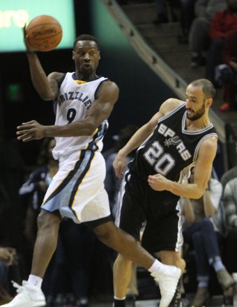 Tony Allen makes a leaping save as Manu Ginobili of the Spurs tries to avoid the contact. (Photo: Warren Roseborough)