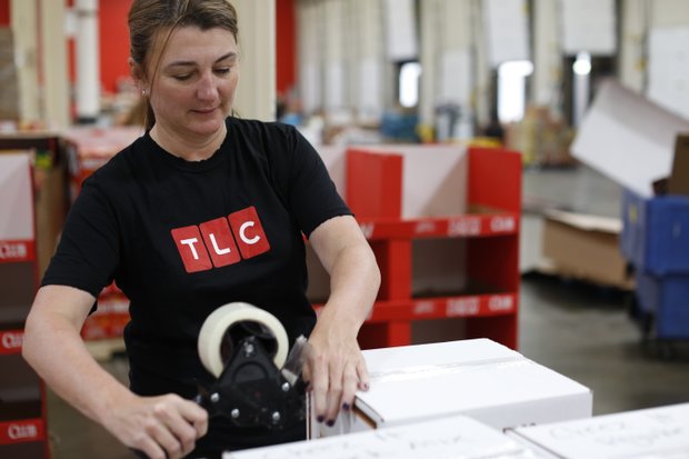 Vicki Lowell, EVP of Marketing for TLC, worked alongside talent and employees to package and sort food at the Maryland Food Bank.