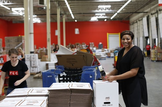 Yuneisia Harris of TLC's CURVY BRIDES(r.) worked alongside TLC employees at the food bank on Tuesday, June 23.