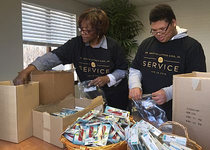 Volunteers of The Perfecting Church MLK Day of Service assemble care packages for victims of human trafficking and domestic violence supported by A Woman's Business and Dining for Dignity.