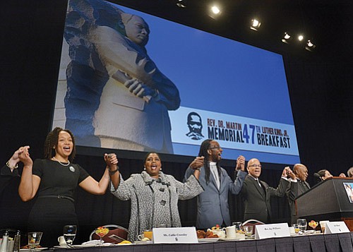 The conclusion of the annual Martin Luther King Jr. Breakfast singing of “We Shall Overcome,” the civil rights anthem, was sung with particular purpose in this time of political uncertainty by keynote speaker Callie Crossley (second from left), co-chair Rev. Jay Williams, master of ceremonies Jose Masso and co-chair Rev. Dr. Monrelle Williams. Speeches were given by Rep. Ed Markey, Attorney General Maura Healey, Sen. Elizabeth Warren and state Sen. Chang-Diaz, among others.