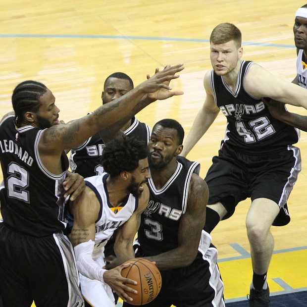 Mike Conley had nowhere to go on this drive to the basket as the San Antonio Spurs collapsed on the Grizzlies Star Saturday March 18 at FedExForum.