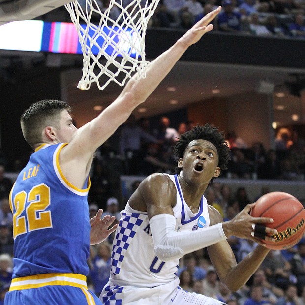 De'Aaron drives to the basket and scores on TJ Leaf of UCLA.