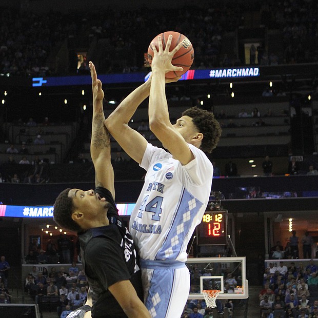Justin Jackson of North Carolina (right) shoots and scores over Kethan Savage. North Carolina defeated Butler 92-80.