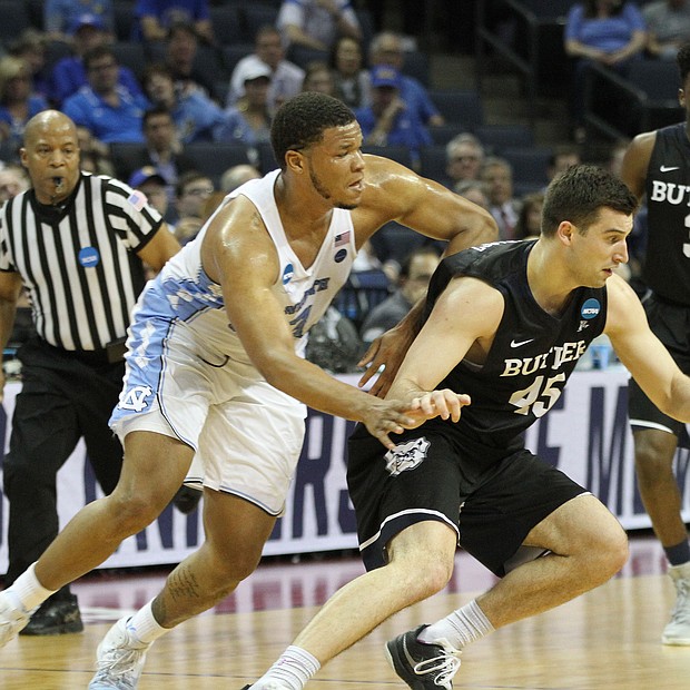 Kennedy Meeks of the North Carolina Tar heals tries to come up with a steal on Andrew Chrabascz of North Carolina.