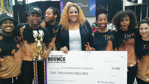 Roxbury-based Trend En Motion, first prize winner of the Beantown Bounce, hold their $1,000 check along with special guest judge Andretta Garnes (center). The “BOUNCE” brought 1,500 fans to Reggie Lewis Track & Athletic Center in Roxbury on April 15, where they cheered on teams of talented dancers, singers and rappers. The annual Beantown Bounce was started by four female artists in 2005 to showcase youth talent and combat neighborhood violence.