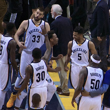 With the 110-108 OT victory in the record books, Marc Gasol, who hit the game-winner, celebrates with his Griz teammates as Spurs Head Coach Gregg Popovich exits the FedExForum court. (Photo: Karanja A. Ajanaku)