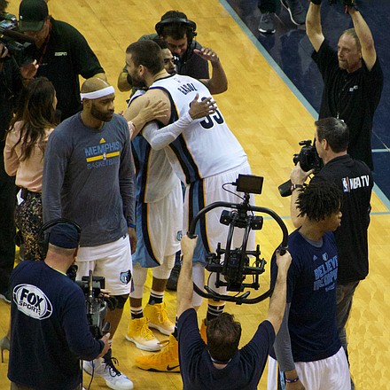 The victory secured, Mike Conley and Marc Gasol embrace before telling television audiences about the epic Game 4 win that knotted the series at 2-2. (Photo: Karanja A. Ajanaku)