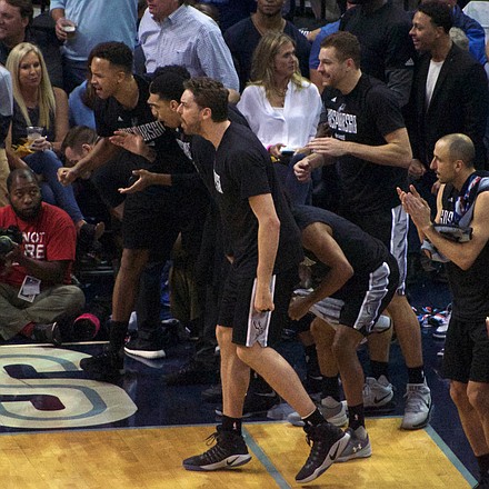 Patty Mills' circus-like drive to the basket drew plenty of bench support in a swing of momentum to the Spurs. (Photo: Karanja A. Ajanaku)