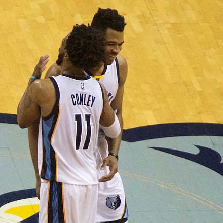 Way to go young fella: The Grizzlies star of the game Mike Conley shows Andrew Harrison how much he appreciated the rookie's hustle in tracking down and blocking the shot of the Spurs' Patty Mills with the game on the line. (Photo: Karanja A. Ajanaku)