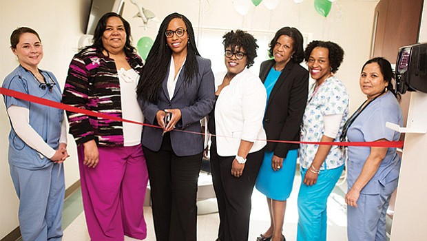 City Councilor Ayanna Pressley (3rd from left) cuts the ribbon on the Codman Square Health Center’s new Pedi Dental suite located in its Pediatric and Adolescent Department with staff and Codman Square Executive Director Sandra Cotterell (3rd from right).