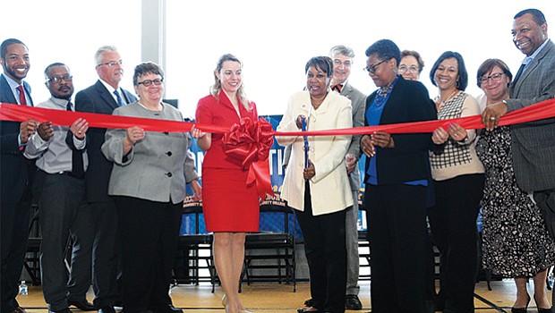 On Friday, April 28, Roxbury Community College, Ameresco and the Division of Capital Asset Management and Maintenance (DCAMM) celebrated the completion of RCC’s Renewable Energy Project. Highlights of this project include a solar canopy comprising 3,000 solar panels above parking lot #1, and 115 geothermal wells, 500 feet deep beneath parking lot #1, which function as the college’s heating and cooling source. (l-r) Chief of Environment, Energy and Open Space Austin Blackmon, RCC Student Trustee Jusu Coker, Ameresco Executive Vice President David J. Anderson, State Representative Liz Malia, Department of Energy Resources (DOER) Commissioner Judith Judson, RCC President Valerie Roberson, RCC Vice President Kevin Hepner, RCC Vice President Lorita Williams, DCAMM Commissioner Carol Gladstone, RCC Chief Human Resources Officer Pat West, RCC Vice President Cecile Regner and RCC Trustee and Sheriff of Suffolk County Steven Tompkins.