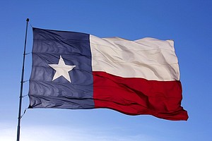 The flag of the State of Texas flies atop a flag pole