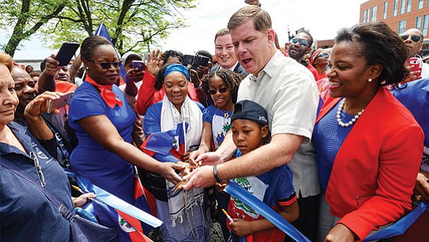 State Rep. Dan Cullinane, Mayor Martin Walsh and state Sen. Linda Dorcena Forry joined community members to help cut the ribbon before the start of the annual Haitian Unity Parade in Mattapan.