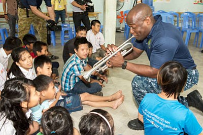 Musician 1st Class Vince Moody, from Severn, Maryland, of the U.S. 7th Fleet Band, Far East Edition, plays trumpet with ... Musician 1st Class Vince Moody, from Severn, Maryland, of the U.S. 7th Fleet Band, Far East Edition, plays trumpet with ...