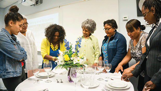 Participants in our event planning course learn the art of table setting and design.