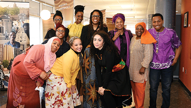 Members of RCC's Muslim Student Association pose with Okolo Rashid, co-founder of the International Museum of Muslim Cultures, after her lecture on the Legacy of Timbuktu Exhibit.