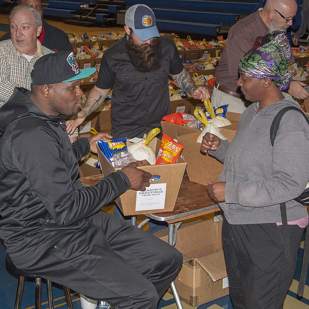 Randolph hands off the assist to a fan at Hamilton High School. Z-Bo routinely donated holiday meals to families in need.
(Photo: Shirley Jackson)