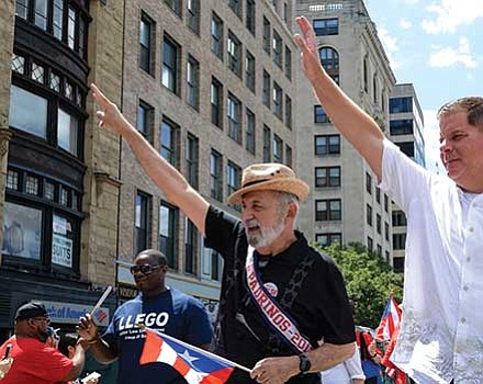 Suffolk County Register of Probate Felix D. Arroyo and Mayor Martin Walsh march in the parade.
