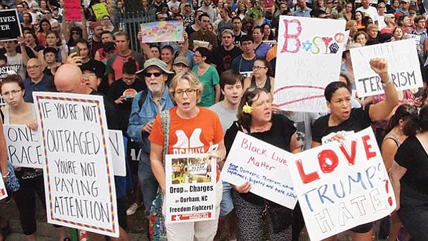 Many protestors’ signs referenced the fatal events in Charlottesville the week before. “If you’re not outraged, you’re not paying attention,” is the last Facebook post written by Heather Heyer, who was killed in Charlottesville while protesting the white supremacist rally.