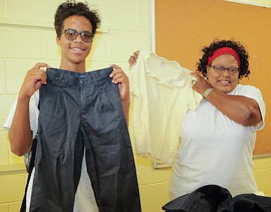 Camden County Technical School student volunteer, Fransico Lora and Lawnside School's Spanish Teacher, Angela Combs were station at the free uniform table.