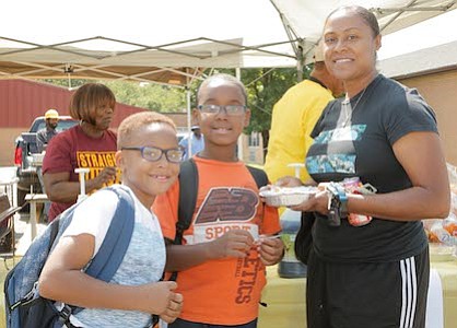 Parent, Sharee Huff with sons, Shane and Zachary Huff taking part of the food vendor, Nellie's Place.