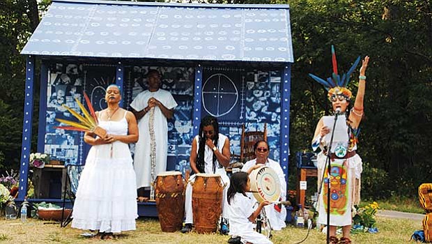 Patricia Chalinaru Dones (right), representing a Taino native, gives her blessing to the Cabin/Praise House created by artist/performer Ife Franklin (left) Sunday, Sept. 10 at Franklin Park.