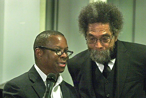 Kevin Peterson (L), founder of the New Democracy Coalition and sponsor of the evening with Dr. Cornel West takes a moment with West to help field audience response