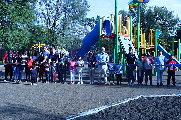 Joliet Park District officials, residents and other community members celebrated the grand opening of Warren-Sharpe Park with a ribbon cutting. Joliet Park District officials, residents and other community members celebrated the grand opening of Warren-Sharpe Park with a ribbon cutting.