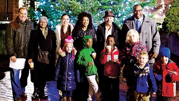 Members of the Roxbury community joined together to celebrate Cruz Companies’ 32nd Annual Holiday Tree Lighting Ceremony at the Cox Building this week (l-r) Dan Cruz, Jr. Sr. VP, Cruz Companies; Candice Sealy, district rep. for Congressman Capuano; Sen. Sonia Chang-Diaz; Barbara Cruz; John B. Cruz, III, president, Cruz Companies; City Councilor Tito Jackson, and Roxbury community youth.