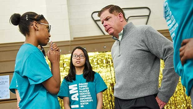 Mayor Martin Walsh speaks with teens during the Boston Centers for Youth and Family Youth Job & Resource Fair in Roxbury.