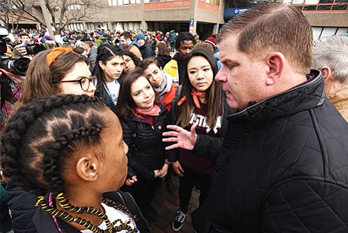 Mayor Martin Walsh talks with teens participating in the March For Our Lives event at Madison Park High School to show his support.